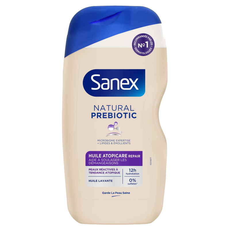 Flacon d'huile lavante Sanex Natural Prebiotic, gamme "Huile Atopicare Repair" pour "Peaux réactives à tendance atopique". L'étiquette violette porte le sceau "Recommandé No. 1 par les dermatologues".